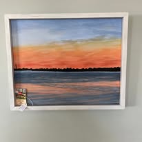 Sunset over water painting by local artist Jessica Abbott, on display at Intracoastal Outboard
